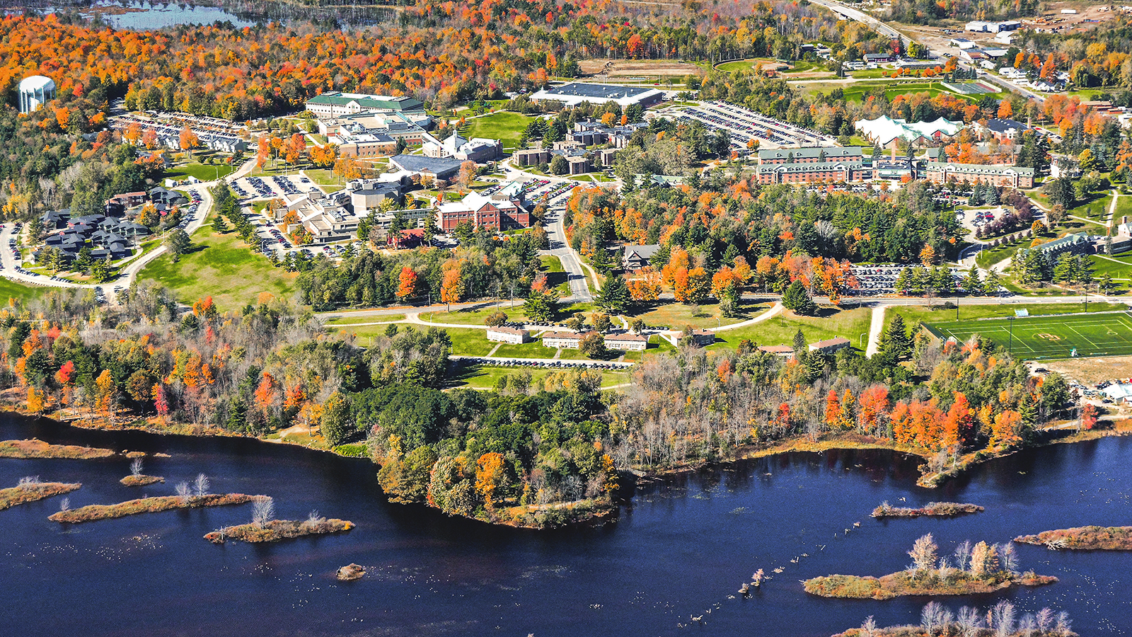 aerial view of Clarkson University from the Racquette River in the fall aerial view of Clarkson University from the Racquette River in the fall